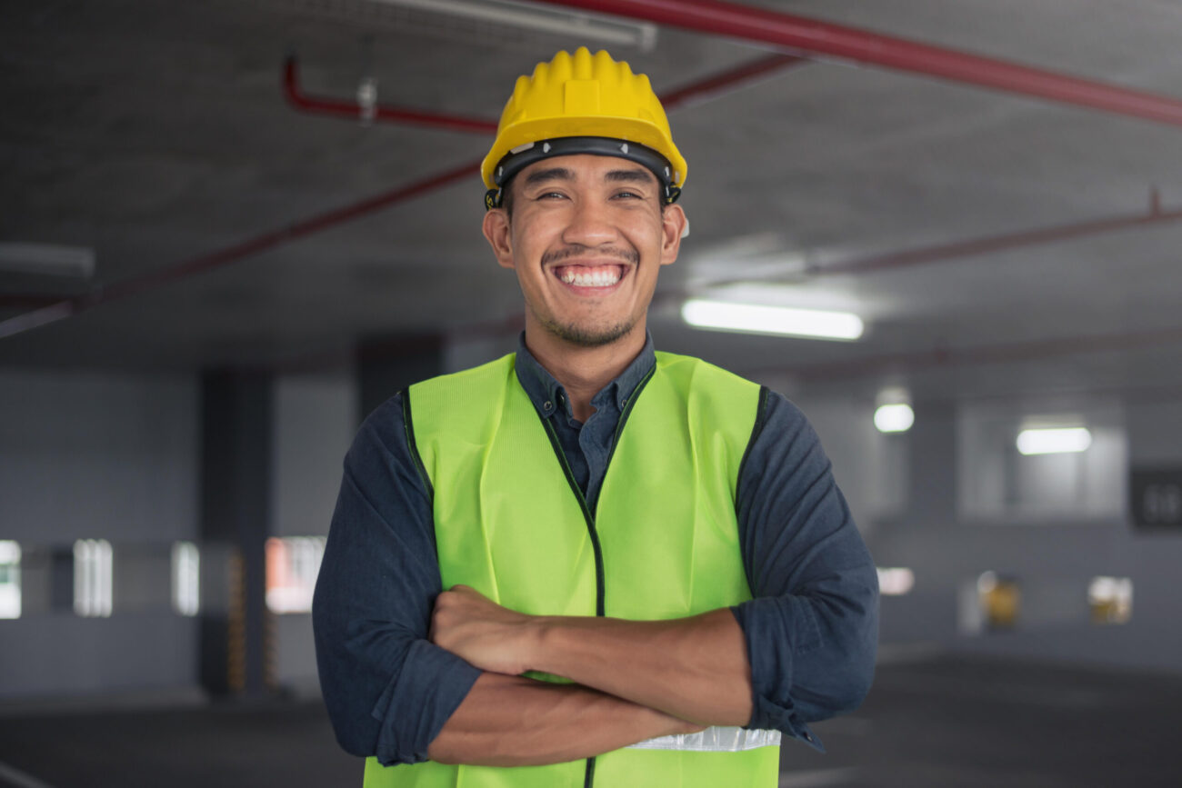 Construction worker smiling with drone. asian contruction worker at building site. 作業員